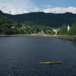 The waters near the Saguenay Fjord offer kayakers amazing views of the Quebec countryside.